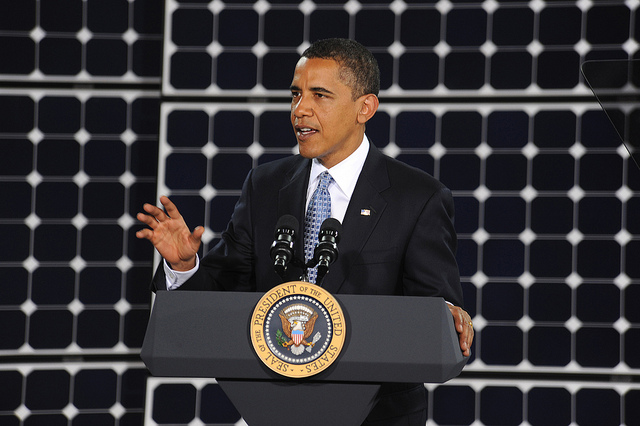 obama doubles renewable energy funding in front of solar panels